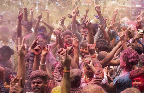 Revellers dancing in the beat of music as they celebrate Holi on a street, the Hindu spring festival of colours on March 25, 2024 in Guwahati, Assam, India. Holi, also known as the Festival of Colors or the Festival of Spring, is one of the most vibrant and joyous festivals in India