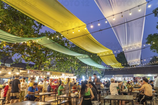 Dining tables at the night market in Luang Prabang, Laos, Asia
