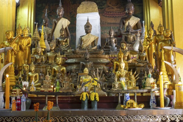 Numerous Buddhas and the city pillar, which is considered the home of the city's protective spirit, Wat Si Muang temple complex, Vientiane, Laos, Asia