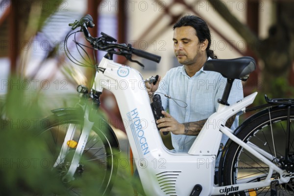 Pilot project for the production and application of green hydrogen (gH2) in the field of micromobility (cargo bikes) to save CO2. University of Rio de Janeiro. A bicycle is refuelled with hydrogen. Rio de Janeiro, 22.07.2024. Photographed on behalf of the Federal Ministry for Economic Cooperation and Development