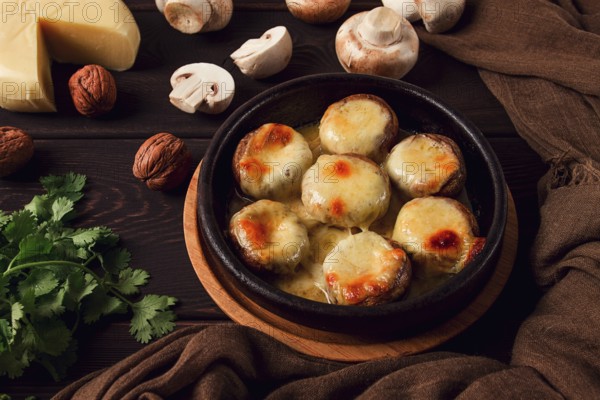 Traditional Georgian dish, appetizer, stuffed mushrooms, Sulguni cheese, baked in a Ketzi clay pan, on a wooden table, close-up, no people