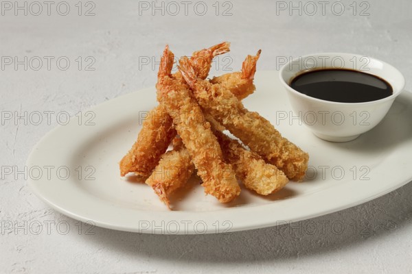 Fried shrimp, peeled in tempura, soy sauce, close-up
