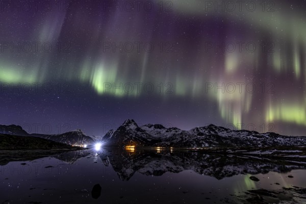 Northern lights over fjord, steep mountains, winter, aurora borealis, Flakstadoya, Lofoten, Norway, Europe