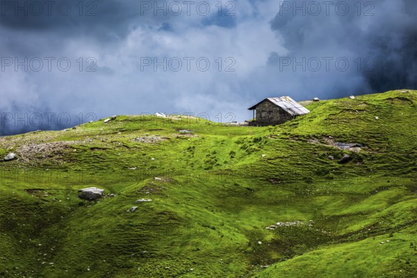 Serenity serene lonely scenery background concept, house in mountains on alpine meadow in clouds. Rohtang La pass, Himachal Pradesh, India, Asia