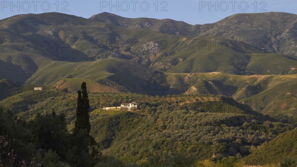 Landscape with green hills and scattered houses against a background of majestic mountains, Lefka Ori, White Mountains, Mountain Massif, West, Crete, Greece, Europe