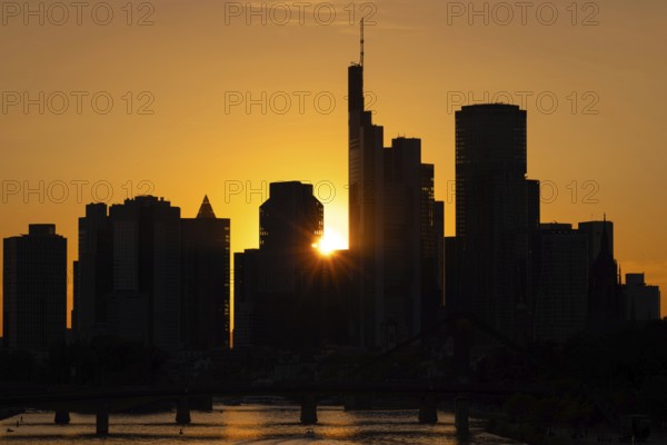 The sun sets behind the Frankfurt banking skyline, Frankfurt am Main, Hesse, Germany, Europe