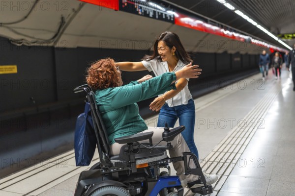 Happy disabled woman meeting a chinese female friend in the metro platform smiling and embracing together