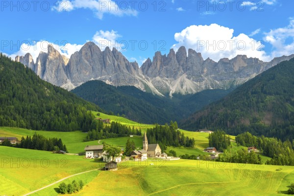 Scenic summer landscape with the famous chiesa di santa maddalena and the odle peaks in funes valley, dolomites