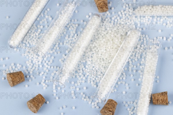 Corks and white beads are scattered on a blue surface