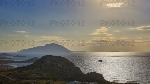 Glittering sea in front of islands in the evening light with dawning sky, Arkasa, west coast, Kassos Island, Karpathos, Dodecanese, Greek Islands, Greece, Europe