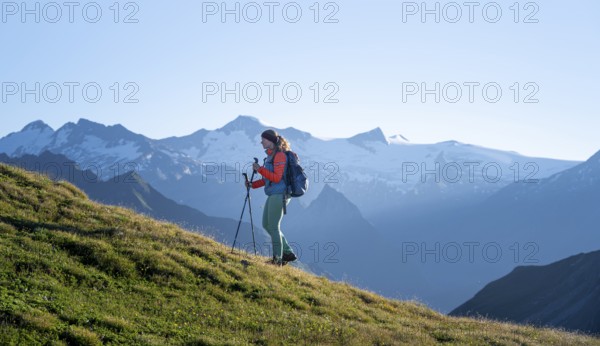 Hiker enjoying the mountain panorama in the morning, Venediger group, behind Dreiherrenkopf, Simonysitze and Großer Geiger, Hohen Tauern, Austria, Europe