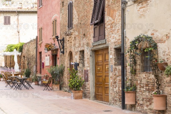 Cosy mix of old houses, shutters and street cafés in the old town of Certaldo, Tuscany, Italy, Europe