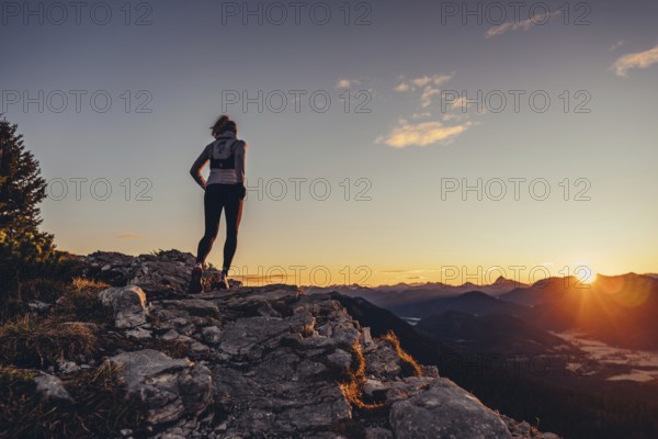 Trail running in autumn on the Jochberg on Lake Walchensee against the wonderful backdrop of the Alps, Bavaria, Germany, Europe