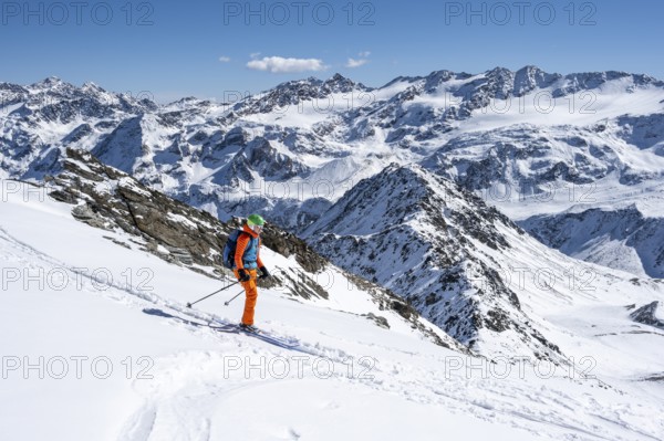 Ski tourer in front of a mountain panorama with snow-covered mountain landscape in winter, Ortler Alps, Vinschgau Valley, Italy, Europe