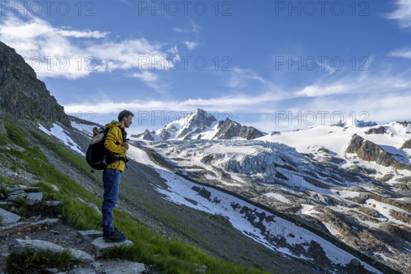 Mountaineer in front of high alpine mountain landscape, summit of the Aiguille de Chardonnet and Glacier du Tour, glacier and mountain peak, Chamonix, Haute-Savoie, France, Europe