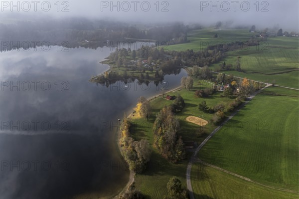 Sports facility and bathing area, lake Rottachsee, shore covered with fog, autumn, aerial view, Allgaeu, Bavaria, Germany, Europe