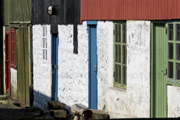 Detail of traditional whitewashed houses with colour-painted timber cladding, Mykines Island, Faroe Islands, Denmark, Europe