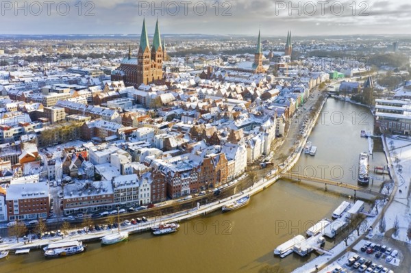 Aerial view over the river Trave and church towers in the old town of the Hanseatic City of Lübeck in winter, Schleswig-Holstein, Germany, Europe