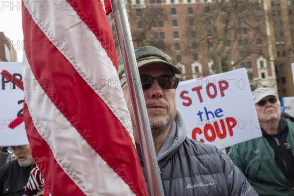 Lansing, Michigan USA - 5 February 2025 - People rally at the Michigan state capitol to oppose President Trump, Elon Musk, and Project 2025. Similar rallies were planned across the country, many of them at state capitols