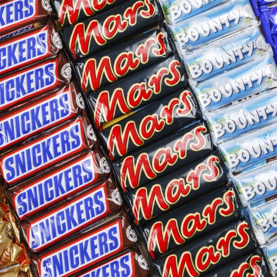 Mars Incorporated products such as Snickers chocolate bars, Twix, Milky Way and Bounty bars as a square background