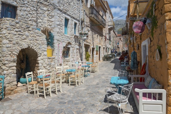 Dreamy alley with colourful houses and a cosy bistro area, Old Town, Areopoli, Areopolis, Tsimova, Itylo, Anatoliki Mani, Mani, Laconia, Peloponnese, Greece, Europe