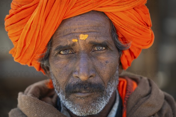 Man with orange turban and yellow bindi on his forehead, portrait, Chittorgarh Fort, Chittorgarh, Rajasthan, India, Asia