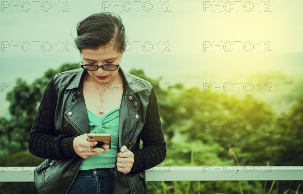 Beautiful urban girl checking and texting phone. Latin woman checking phone outdoors