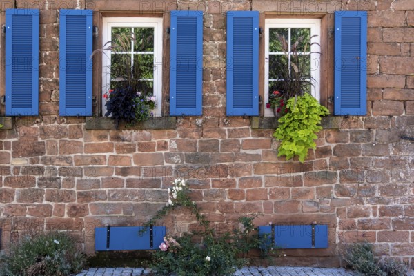 Rustic house façade with windows, blue shutters and flowering plants, Weyher, Southern Palatinate, Palatinate, Rhineland-Palatinate, Germany, Europe