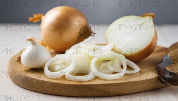 Vegetables, onion, Allium cepa, freshly sliced onion rings and finely chopped onion on a wooden board