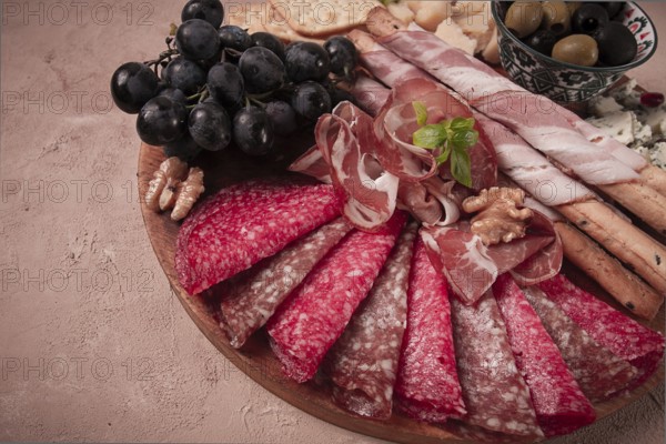 Appetizer, assortment, set, sausage, and cheese, on a wooden board, top view, no people