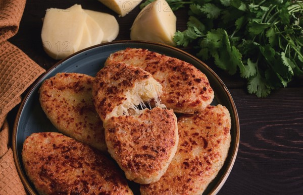 Chvishtari, corn flour tortillas with cheese, pastries, Georgian cuisine, Mchadi, homemade, top view, on a wooden table, no people