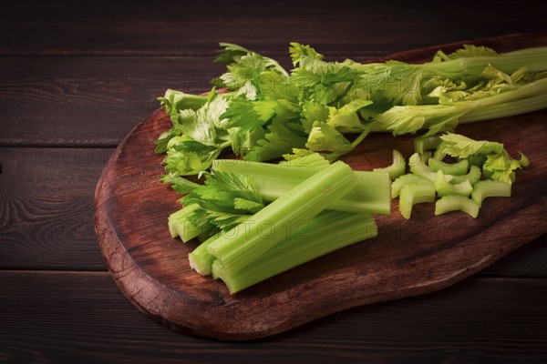 Fresh bunch of celery, top view, no people, on a dark background