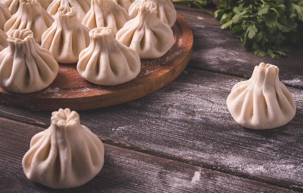 Raw khinkali, Traditional Georgian dish, on a wooden table, selective focus, rustic, no people