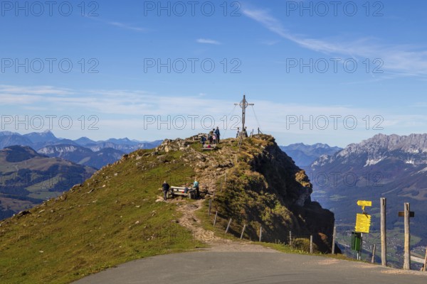 Hiking on the Kitzbüheler Horn in Tyrol: summit cross with a view on a pre-summit just below the Kitzbüheler Horn
