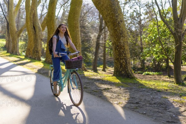 Student enjoying cycling in a park during a sunny spring day, promoting sustainable mobility and healthy lifestyle