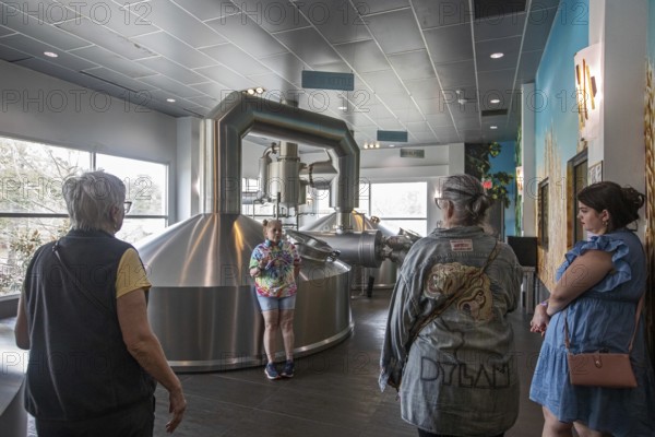 Covington, Louisiana - The Abita Brewing Company's craft beer brewery. A tour guide explains the brewing process to visitors