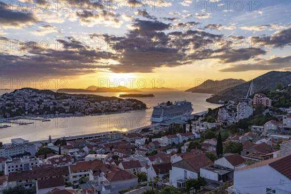 Cruise ship Norwegian Escape in the harbour of Dubrovnik at sunset, Croatia, Europe