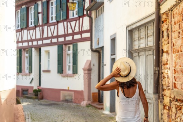 A female tourist walking in the village of Gengenbach in the Black Forest, Germany, Europe