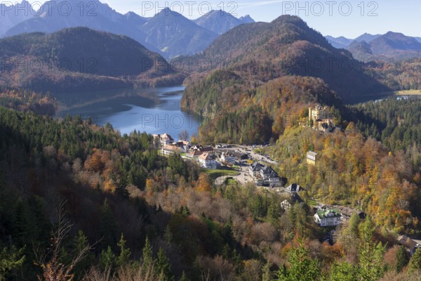 Idyllic valley with autumn-coloured forest, enchanting mountains and a tranquil lake, Schwansee, Hohenschwangau Castle, Schwangau, Ostallgäu, Allgäu, Swabia, Upper Bavaria, Bavaria, Germany, Europe