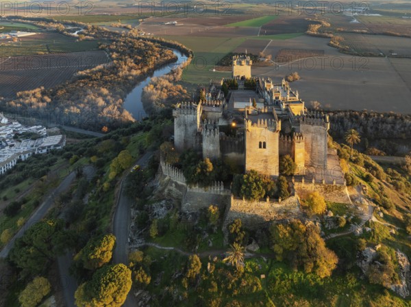 The impressive eighth-century Moorish castle of Almodóvar del Río perches high above the Guadalquivir river valley. Aerial view. Drone shot. Córdoba province, Andalusia, Spain, Europe