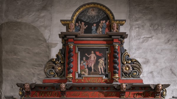 Close-up, richly decorated wooden altar in front of a stone wall, decorated with images of saints, Skedsmo Pilgrims' Church, Skedsmokorset, Norway, Europe