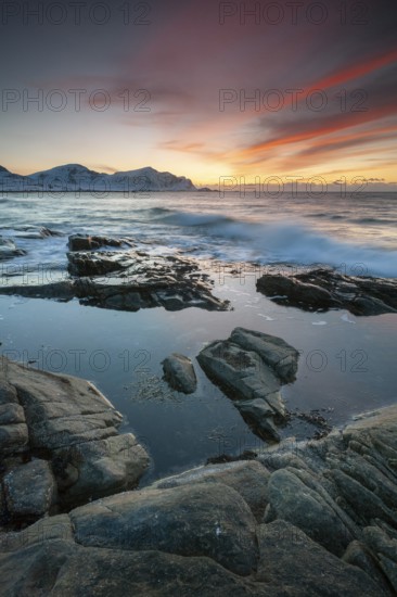 Sunset in winter at Skagsanden, rock formations on the beach at Flakstad, Flakstadøy, Lofoten, Nordland, Norway, Europe