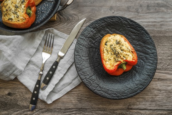 Close-up view of roasted bell peppers stuffed with goat cheese and mozzarella on wooden table