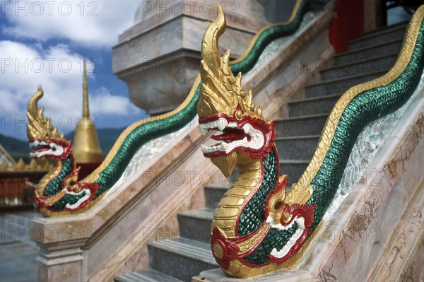 Dragon on staircase of tower with top of Chedi highest building in temple complex buddhist monastery Wat Chalong Wat Chaitararam, Phuket, Thailand, Asia