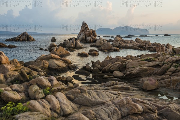 Lonely beach with granite rocks, sunrise, Spiaggia Poltu Manzu, Capo Ceraso, near Olbia, Sardinia, Italy, Europe