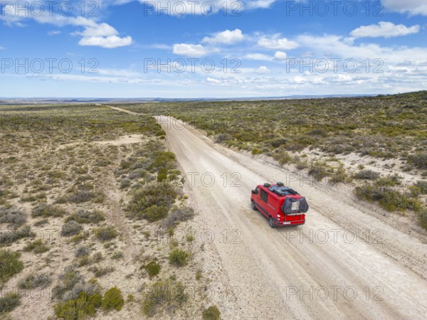 4x4 campervan drives along the road near Estancia la Maciega, Chubut, Argentina, South America