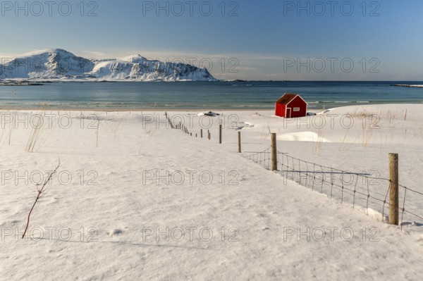 Red hut, snowy landscape, sea, mountains, Lofoten, Northern Norway, Norway, Europe
