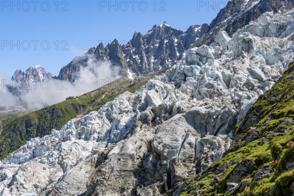 Glacier ice of the Glacier des Bossons, behind pointed mountain peaks, Chamonix, Haute-Savoie, France, Europe