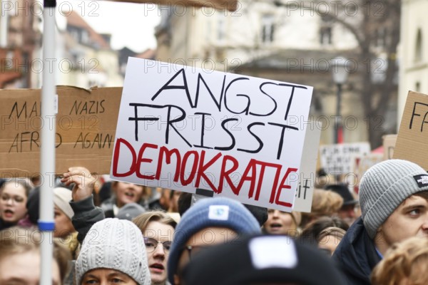 Heidelberg, Germany - February 12th 2025: Person holding up sign with text 'Fear eats democracy in crowd at protest against far-right