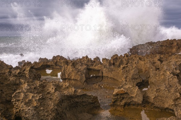 The rocks are scattered throughout the area, with some of them being large and jagged. The water appears to be rough. Rabat, Morocco, Africa